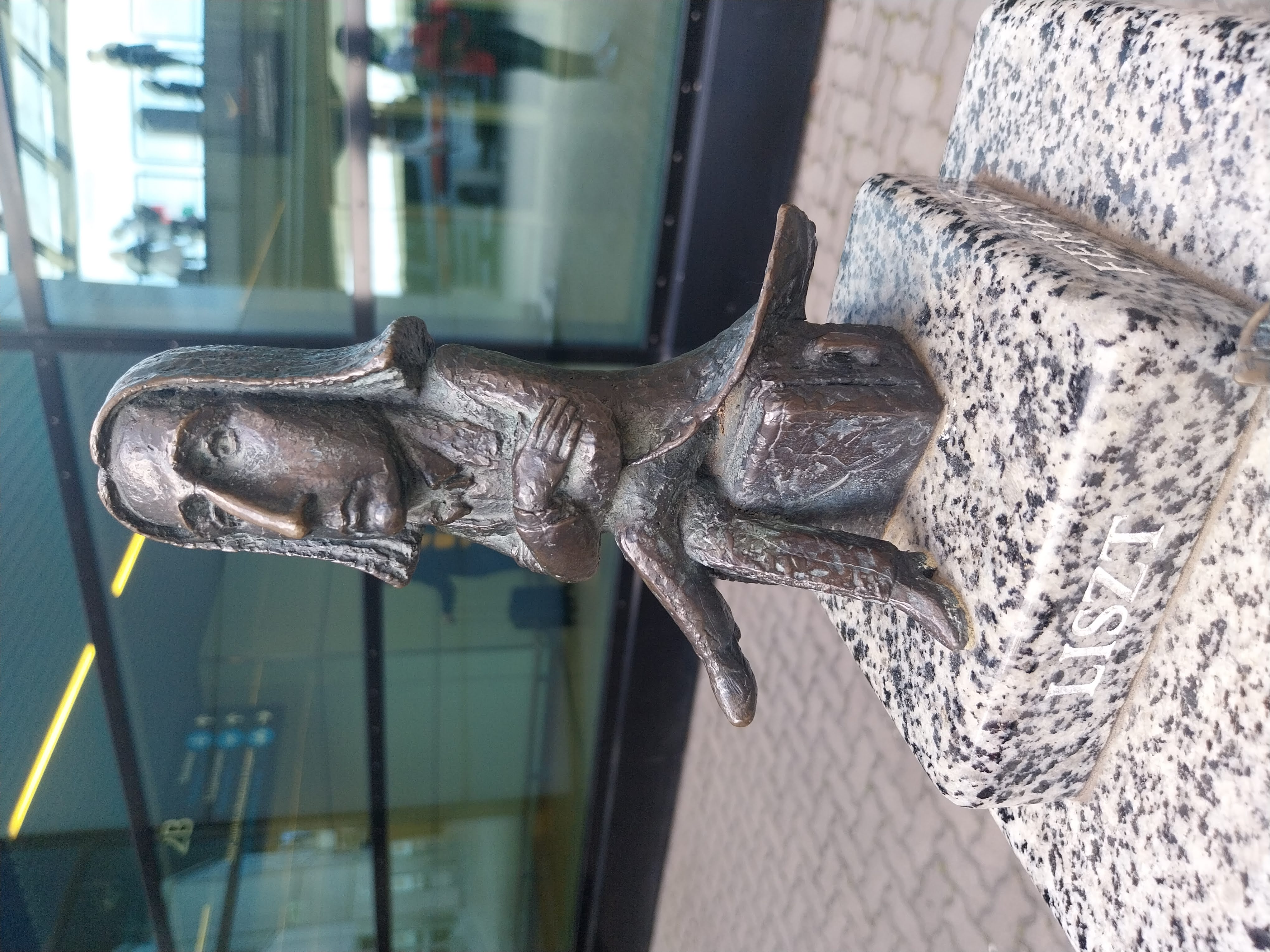 Liszt's mini statue in front of the airport, before being moved inside in 2025